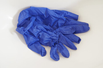 Blue Used Latex Gloves in White Sink.