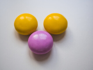 Top view of yellow and purple chocolate candy with copy space.