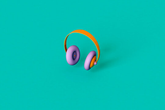 Multi colored headphones on green background