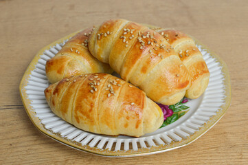 Traditional Serbian  homemade rolls with sesame (kiflice) on the vintage plate, close up