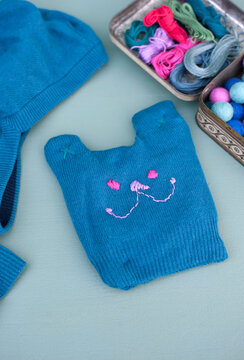 DIY teddy bear made of blue sweater sleeve