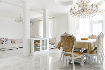 living room dining room interior in white with dining table and chairs, sofa, columns, windows,...