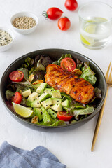 Salad with chicken, avocado and tomatoes. Healthy eating. Vegetarian food.
