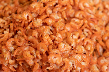 Close-up of dried shrimp, stacked on a tray.