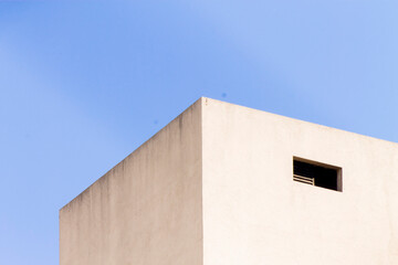 A perspective view of a building and the blue sky. An architecture and nature mix.