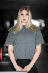 Portrait of a young beautiful athletic blonde in the fitness room.