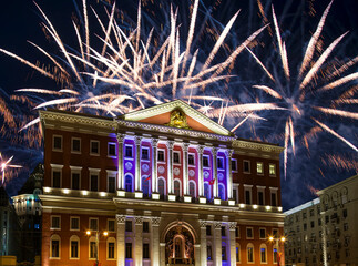 Fototapeta na wymiar The building of the residence of the Mayor of Moscow with illumination at night, against the background of fireworks. Moscow, Russia