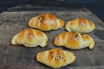 Homemade  Serbian dinner rolls( kiflice) with caraway seeds  on the rustic wooden background