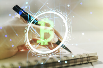Creative Bitcoin concept with woman hand writing in notebook on background. Multiexposure