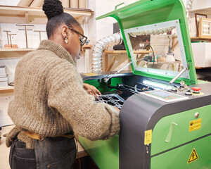 woman operating a laser cutter