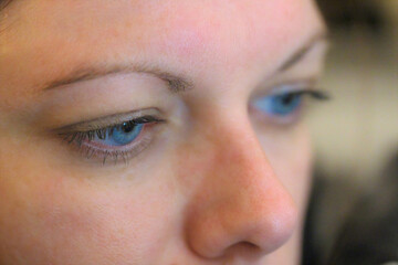 Close shot of blue-eyed woman face