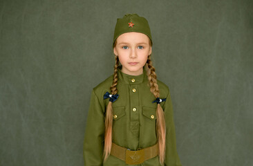 Portrait of a little girl in a military uniform. Victory Day on May 9.