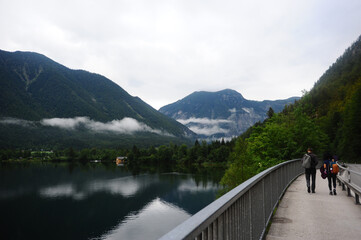 Young couple walking near the road with backpacks on their back