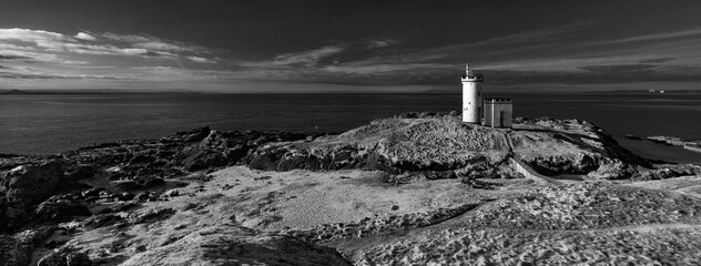 lighthouse on the shore of the sea