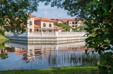 Beautiful Mediterranean Style Condominium Reflecting on Lake Surrounded by Trees