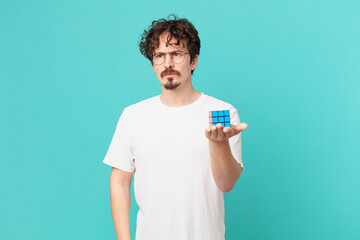 young man solving an intelligence problem feeling sad, upset or angry and looking to the side