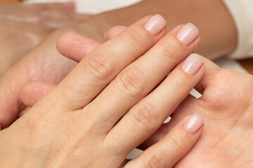 A finished manicure in a beauty salon. Hand close-up, nails, nail polish, color, brush, fingers, manicurist