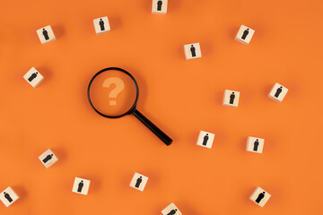 Search for talent or search for an employee concept using a magnifying glass and wooden cubes with...