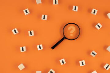 Search for highly qualified employees or talent using a magnifying glass with a question mark on an orange background.