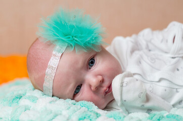 Newborn laying baby with the bow - closeup