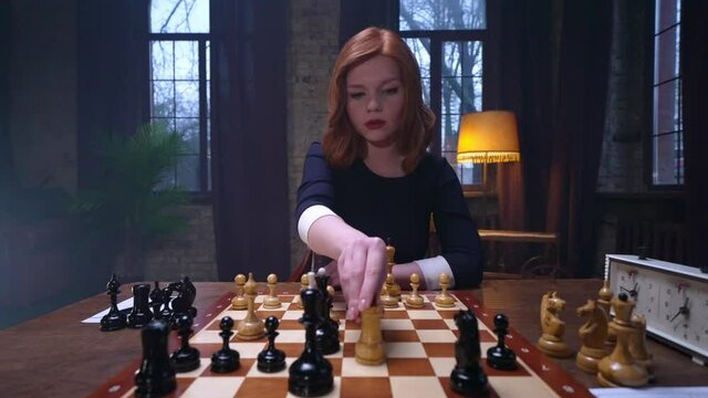 Two chess players man and woman play chess. Debut Accepted Queen's Gambit, King's Gambit, Philidor's Defense. Cinematic filming of a chess game. Antique chess board. This shot can be used for films