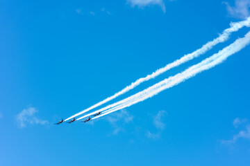 Four aeroplanes flying in formation with smoke trails in New Zealand