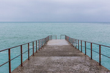 Obraz premium An old abandoned pier sinking into the sea