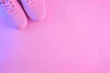 Fashion white sneakers in neon light. Sport shoes for training in the gym. Creative minimalism. 90s...
