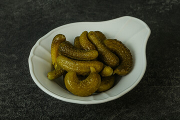 Pickled gherkin in the bowl