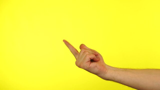 Hand of man waving inviting to join isolated on yellow background. Welcome concept.
