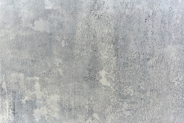 Texture of a wall made of rough metal painted with gray cracked paint