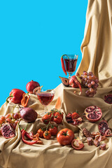 Modern stillife with red food and wine. Blue background