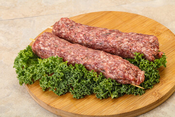 Raw minced beef kebab skewer