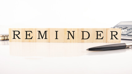 REMINDER word made with building blocks on white background