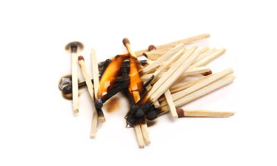 Burnt fire matches pile with flames, burned matchsticks group isolated on white background