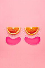 Hydrogel patches for the eyes. Pink under eye patches with collagen on pink background. The concept of beauty, cosmetics for skin care around the eyes, lifting, beauty salon.