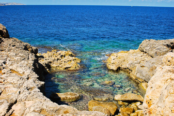 Qawra Point basin in the rocky coast of Malta island near Sea Aquarium in Malta Island on the Qawra...