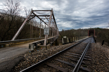 Fototapeta na wymiar Walbridge Bridge - Historic One-Lane Pratt Through Truss Steel Bridge - KY Route 644 + CSX Railroad - Lawrence County, Kentucky