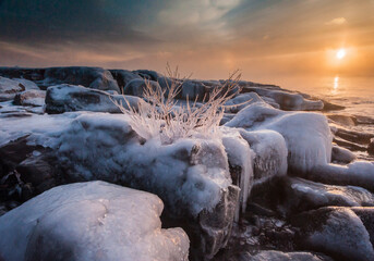 In winter the sun rose slowly over Lake Superior while the open water and -20 F degree air mixed, creating thick wisps of sea smoke. Brighton Beach, Duluth, MN.