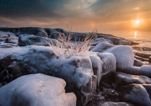 In winter the sun rose slowly over Lake Superior while the open water and -20 F degree air mixed, creating thick wisps of sea smoke. Brighton Beach, Duluth, MN.