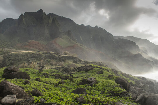Rugged mountains rise steeply out of the ocean on Kauai's Napali Coast.