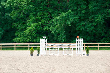 Equestrian obstacles. Empty field with poles for horse jumping competition