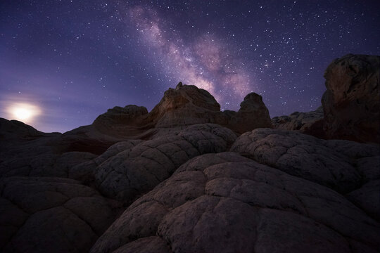 The milky way and rising moon add a subtle glow to this unique landscape in the remote Arizona desert.