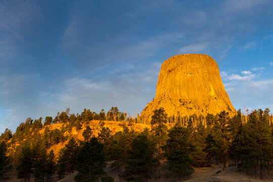 The first light of day hits Devil's Tower in Devil's Tower National Monument, Wyoming.