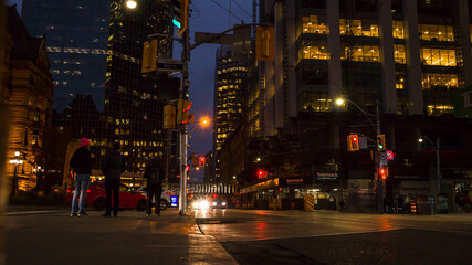 Fototapeta na wymiar night traffic in the city Toronto downtown. Pedestrians, cars and street lights