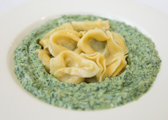 Ravioli spinach ricotta white plate white background. Recipe, vegetarian food, mediterranean diet, healthy meal, fasting, Italian food concept. Copy space