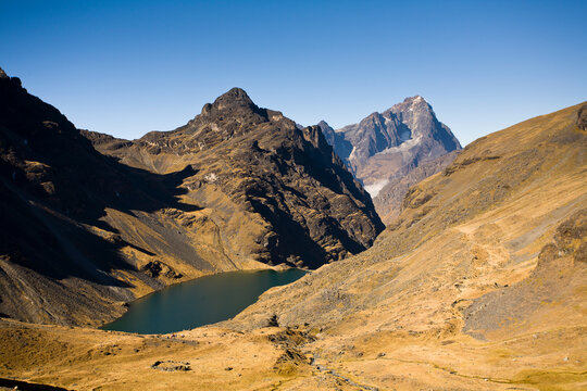 Mt. Tiquimani's rocky summit (18,110') sits at the end of Zongo Valley overlooking Laguna Llivinosa (14,210') in Bolivia's Cordillera Real of the Andes..