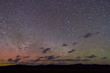 A meteor near the peak of the Lyrid Meteor Shower streaks from the Lyra Constellation as the northern lights and Milky Way Galaxy shine above the northern horizon of Grand Teton National Park, Wyoming.