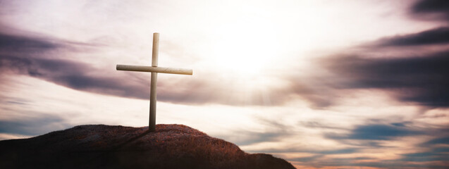 Cross on a beautiful sunset on the mountain - concept of a holy day of the crucifixion of Jesus