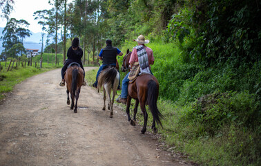 Three people riding a horse